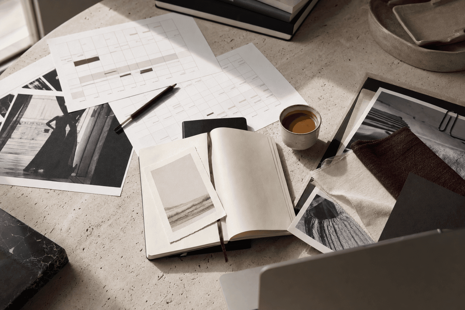Editorial planning desk with fashion research materials and tactile paper textures.